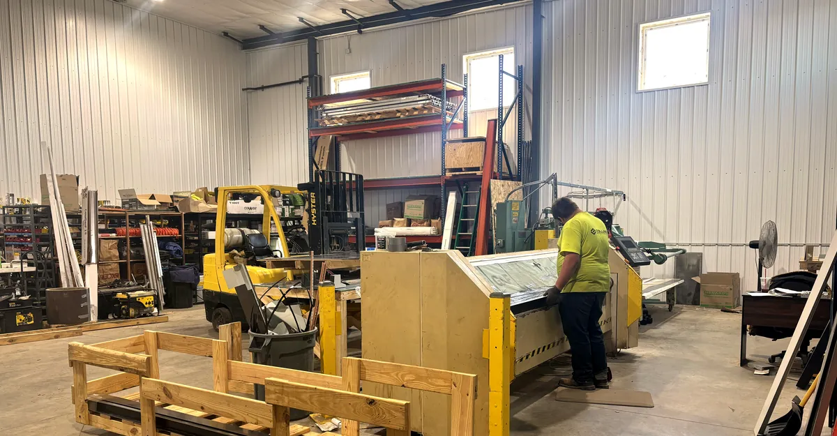 Collins fabricator at the sheet metal brake forming custom trim in the Cloquet shop